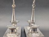 pair of antique silver candlesticks on stands
