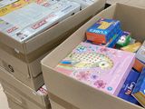 two boxes of toys and books on the floor in a room