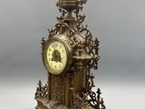 a gold clock sitting on top of a table
