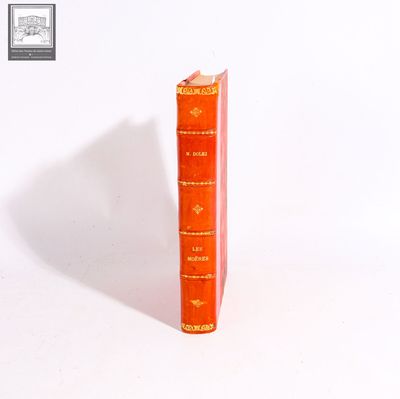 a stack of three books sitting on a white surface