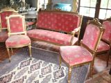four chairs and a couch in a room with a rug on the floor