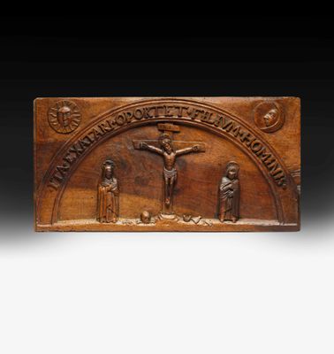 a wooden plaque depicting the crucifix of jesus on the cross