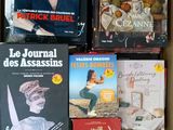 many books that are in a box on the table