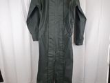 an image of a green jumpsuit hanging on a white curtain