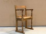 a wooden chair that is sitting in front of a wall