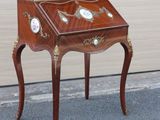 a small wooden table with a clock on it