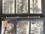 a black binder that has a bunch of old photos inside of it