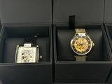 two watches in a box with a watch in the middle of them