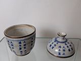 a glass shelf with a bowl and a cup on it