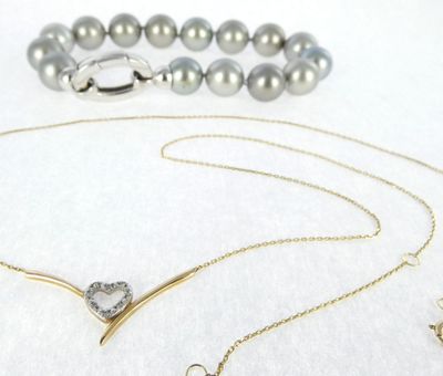 necklaces and bracelets are displayed on a white surface