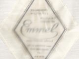 a close up of a white shirt with a diamond on it