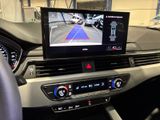 the dashboard of a car with a monitor showing a view of a street