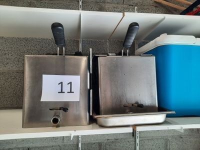 two ice cream dispensers on a shelf next to a blue cooler