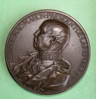 an old bronze medal of a man with a dog on it