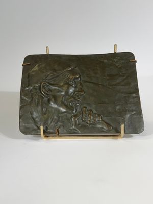 sculpture of a man on a horse on a wooden stand