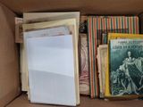 a box full of old books and papers in it