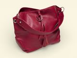 red leather handbag with tassels on a white background