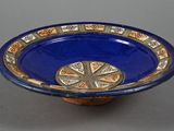 a blue bowl with a decorative design on it