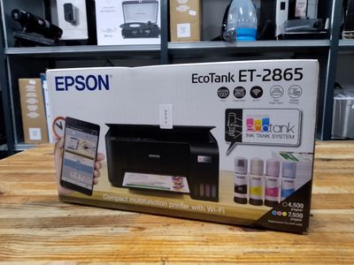 a box with a printer sitting on a wooden table