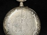 an old silver pocket watch on a black background with a black background