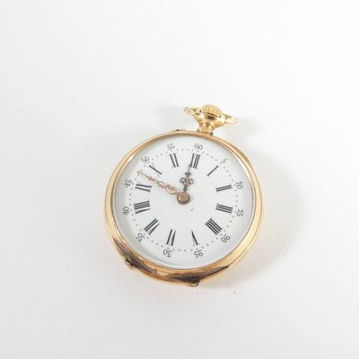a gold pocket watch with roman numerals on the face