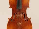 an old violin with a bow hanging from it ' s back