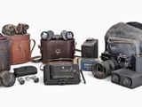 a lot of old cameras and other items on the table