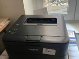 a printer sitting on top of a box on a desk