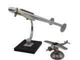 a silver model of a plane on a black base