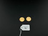 a pair of gold coins with a price tag on them