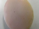 an egg sitting on top of a white table next to a knife