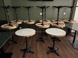 plusieurs tables et tabourets dans une pièce où une télévision est accrochée au mur