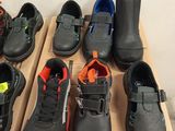 many pairs of shoes that are sitting on a box