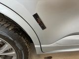 a close up of a car ' s tire with a sticker on it