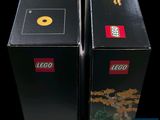 two black boxes with legos sitting side by side on a black background