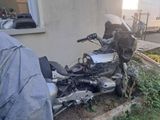 a motorcycle parked next to a building with a tarp on it