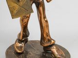 bronze figurine of a man holding a book and a briefcase