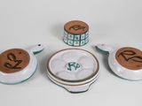three pieces of pottery with numbers on them sitting on a table