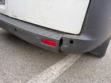 rear bumper of a car with a hole in the middle of the bumper