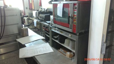 a picture of a kitchen with a microwave and a counter