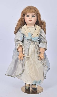a doll that is wearing a dress and shoes