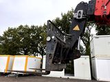 a crane that is lifting a container onto a truck