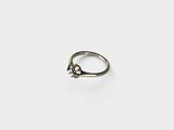 a close up of a silver ring with a small star on it