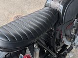 a close up of a motorcycle with a leather seat