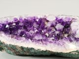 a close up of a large piece of amethorate with purple crystals