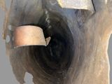 a close up of a piece of wood with a piece of metal sticking out of it