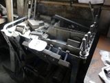 an image of a machine that is working on metal parts