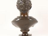 bronze bust of a man on a pedestal with a white background