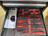 many tools in a tool box on the floor