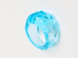 an image of a blue ring sitting on top of a white surface